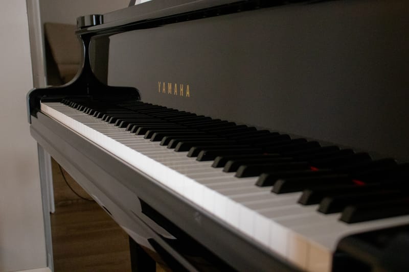 Close-up of the keys of the black grand piano in the worship center.